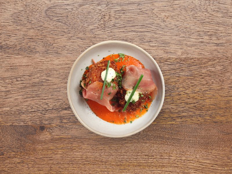 Jamón croquettes on tomato sauce with aioli.
