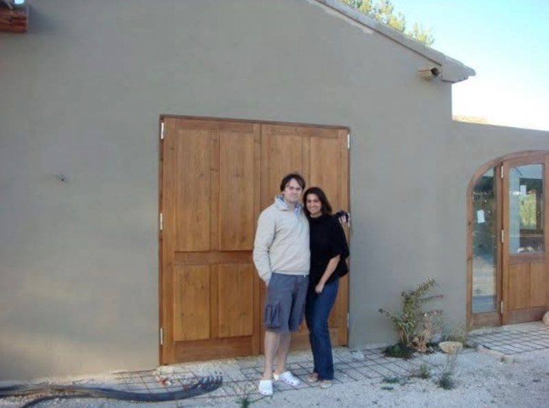 Torsten Schulz and his wife in front of the tall wooden doors of the unfinished El Campo, Jávea, 2008.